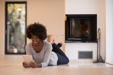 Image showing black women used tablet computer on the floor