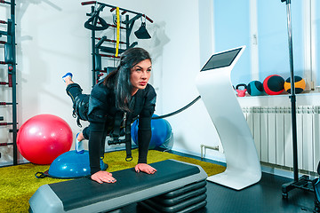 Image showing The female athlete doing they exercise in a ems fitness studio