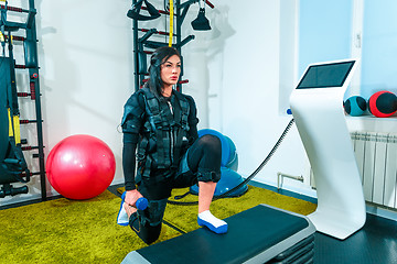 Image showing The female athlete doing they exercise in a ems fitness studio