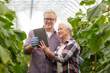 Image showing senior couple with tablet pc at farm greenhouse