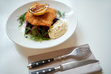 Image showing close up of fish salad with roasted lemon on plate