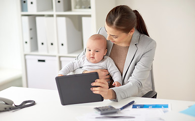 Image showing businesswoman with baby and tablet pc at office