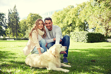 Image showing happy couple with labrador dog walking in city