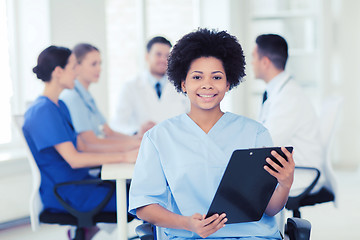 Image showing happy doctor over group of medics at hospital