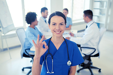 Image showing happy doctor over group of medics at hospital