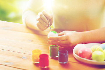 Image showing close up of woman hands coloring easter eggs