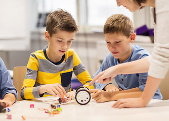 Image showing happy children building robot at robotics school