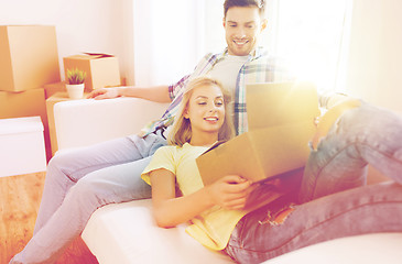 Image showing happy couple with big cardboard boxes at new home