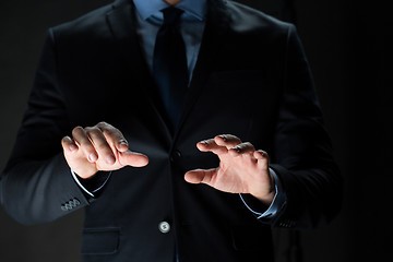 Image showing close up of businessman touching virtual screen