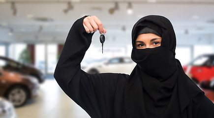 Image showing muslim woman in hijab with car key over car show