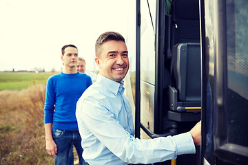 Image showing group of happy male passengers boarding travel bus