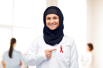 Image showing muslim doctor in hijab with red awareness ribbon