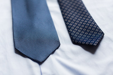 Image showing close up of shirt and blue patterned ties