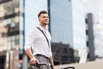 Image showing young man with bicycle on city street