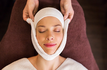 Image showing woman having face massage with towel at spa