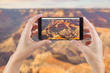 Image showing Female Hands Holding Smart Phone Displaying Photo of The Grand C