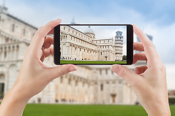 Image showing Female Hands Holding Smart Phone Displaying Photo of The Leaning