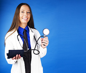 Image showing young pretty woman doctor with stethoscope emotional posing, pointing in camers, lifestyle people concept 