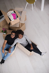 Image showing African American couple  playing with packing material