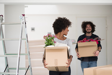 Image showing multiethnic couple moving into a new home