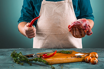 Image showing Butcher with pork meat on kitchen