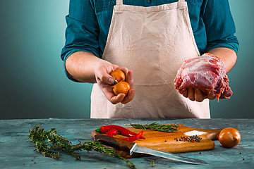 Image showing Butcher with pork meat on kitchen