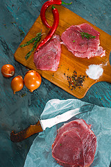 Image showing Pieces of raw pork steak with spices and herbs rosemary