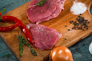 Image showing Pieces of raw pork steak with spices and herbs rosemary