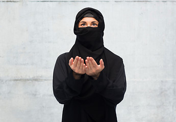 Image showing praying muslim woman in hijab over white