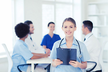 Image showing happy doctor over group of medics at hospital