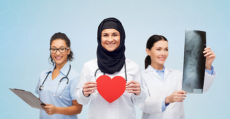 Image showing happy doctors with red heart, x-ray and clipboard