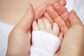 Image showing close up of mother and newborn baby hands