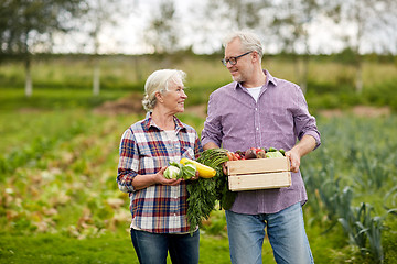Image showing senior couple with box of vegetables on farm
