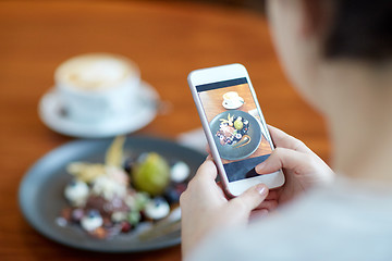 Image showing woman with smartphone photographing food at cafe