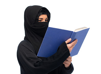 Image showing muslim woman in hijab reading book over white