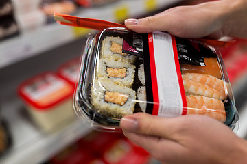 Image showing hands with sushi pack at grocery or supermarket