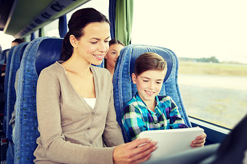 Image showing happy family with tablet pc sitting in travel bus