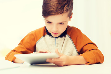 Image showing close up of boy with tablet pc computer at home