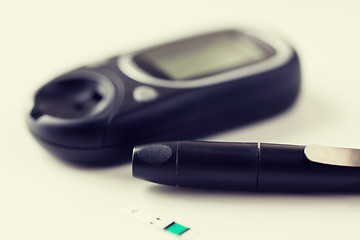 Image showing close up of glucometer and blood sugar test stick