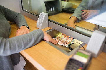 Image showing clerk giving cash money to customer at bank office