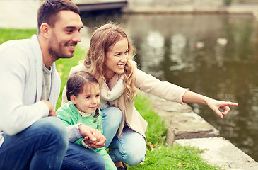 Image showing happy family walking in summer park