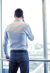 Image showing businessman calling on smartphone in office