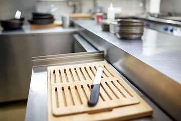 Image showing cutting board and knife at restaurant kitchen