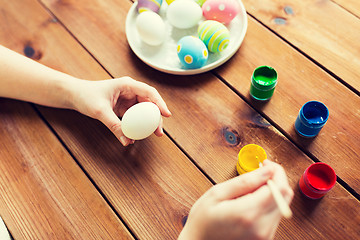 Image showing close up of woman hands coloring easter eggs