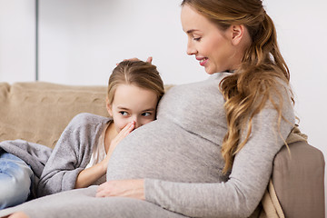 Image showing pregnant woman and girl talking to baby in belly