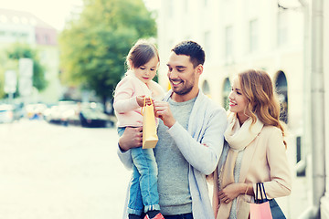 Image showing happy family with child and shopping bags in city