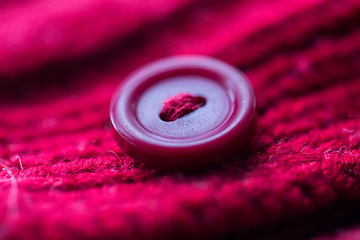 Image showing close up of button sewn to knitted item