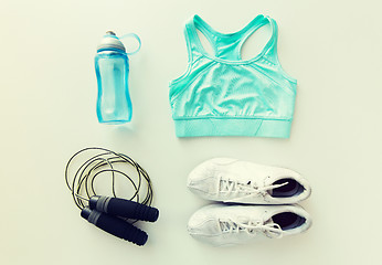 Image showing close up of sportswear, skipping rope and bottle