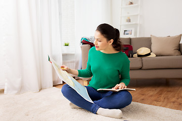 Image showing woman with map planning her travel at home