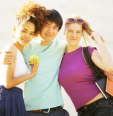 Image showing cute group of teenages at the building of university with books huggings, diversity nations